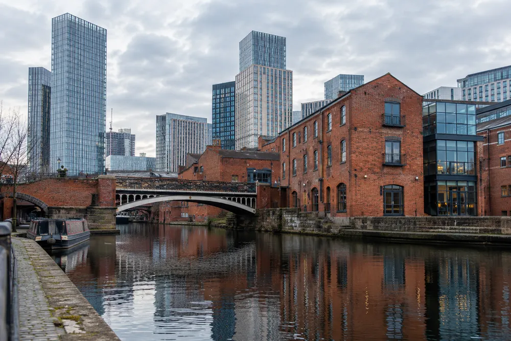 Manchester canal-side brick buildings and modern office skyline